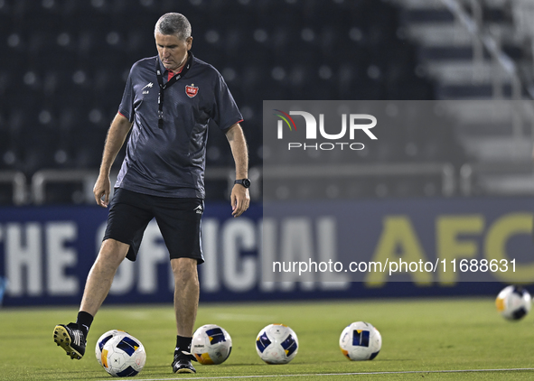 Head coach of Persepolis FC, Juan Carlos Fernandez, participates in a training session at Jassim Bin Hamad Stadium in Doha, Qatar, on Octobe...