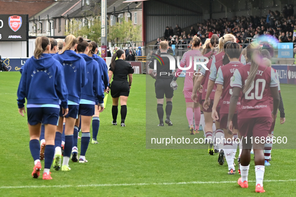 Teams are led out by Referee Tom Parsons during the Barclays FA Women's Super League match between West Ham United and Arsenal at the Chigwe...