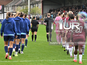 Teams are led out by Referee Tom Parsons during the Barclays FA Women's Super League match between West Ham United and Arsenal at the Chigwe...