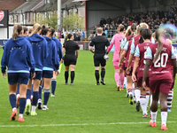 Teams are led out by Referee Tom Parsons during the Barclays FA Women's Super League match between West Ham United and Arsenal at the Chigwe...