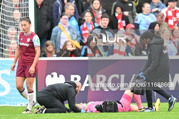 Goalkeeper Kinga Szemik of West Ham receives medical treatment during the Barclays FA Women's Super League match between West Ham United and...