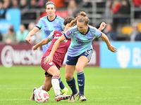 Lia Walti (13 Arsenal) is challenged by Riko Ueki (9 West Ham) during the Barclays FA Women's Super League match between West Ham United and...