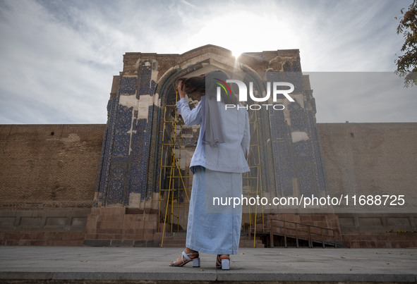 A young Iranian woman stands in front of the historical Blue Mosque in Tabriz, Iran, on October 16, 2024, amid global concerns about war bet...