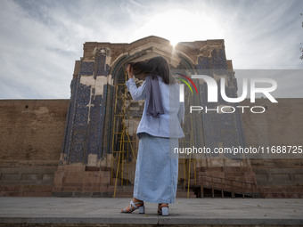 A young Iranian woman stands in front of the historical Blue Mosque in Tabriz, Iran, on October 16, 2024, amid global concerns about war bet...