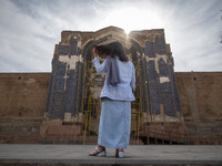 A young Iranian woman stands in front of the historical Blue Mosque in Tabriz, Iran, on October 16, 2024, amid global concerns about war bet...