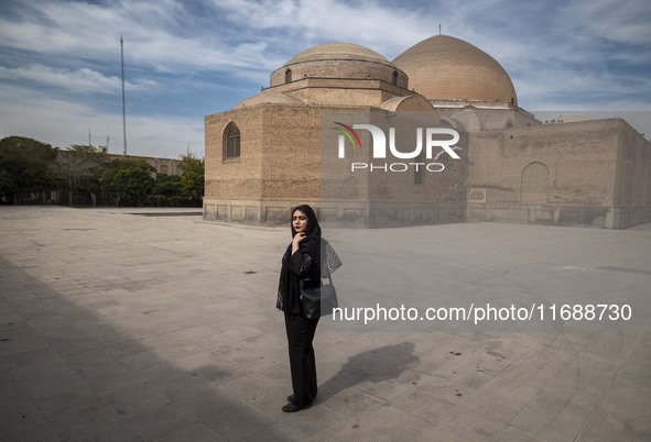 A young Iranian woman poses for a photograph while visiting the historical Blue Mosque in Tabriz, Iran, on October 16, 2024, amid global con...