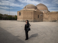 A young Iranian woman poses for a photograph while visiting the historical Blue Mosque in Tabriz, Iran, on October 16, 2024, amid global con...