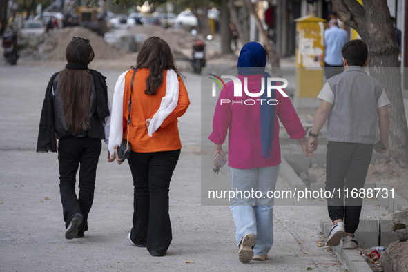 An Iranian family walks together along a street in the historical city of Tabriz, located 624 km (388 miles) northwest of Tehran in the East...