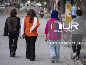 An Iranian family walks together along a street in the historical city of Tabriz, located 624 km (388 miles) northwest of Tehran in the East...