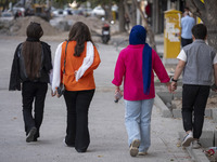 An Iranian family walks together along a street in the historical city of Tabriz, located 624 km (388 miles) northwest of Tehran in the East...