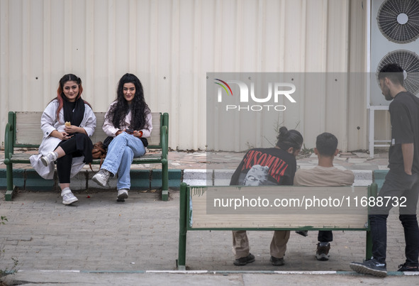 Two young Iranian women sit together in the historical city of Tabriz, located 624 km (388 miles) northwest of Tehran in the Eastern Azerbai...