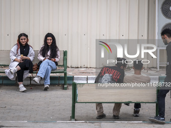 Two young Iranian women sit together in the historical city of Tabriz, located 624 km (388 miles) northwest of Tehran in the Eastern Azerbai...