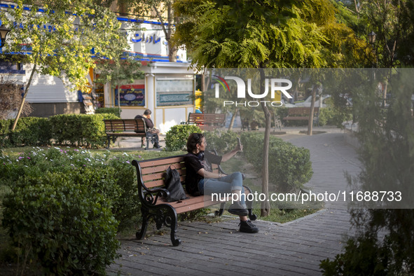 A young Iranian woman takes a selfie while sitting on a bench in the historical city of Tabriz, located 624 km (388 miles) northwest of Tehr...