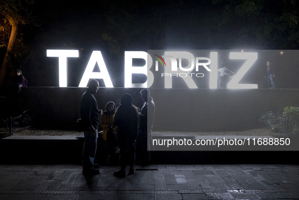 Iranian youths are at a historical site at night in Tabriz, Iran, on October 17, 2024, amid global concerns about war between Iran and Israe...