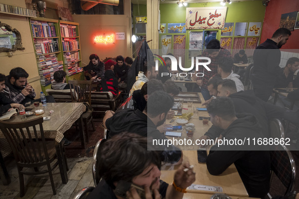 Iranian youths sit at a cafe at night in the historical city of Tabriz, Iran, on October 18, 2024, amid global concerns about war between Ir...