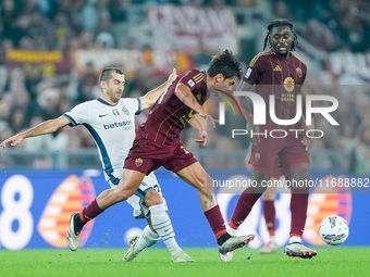 Paulo Dybala of AS Roma and Henrikh Mkhitaryan of FC Internazionale compete for the ball during the Serie A Enilive match between AS Roma an...