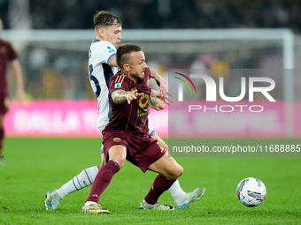 Nicolo Barella of FC Internazionale and Angelino of AS Roma compete for the ball during the Serie A Enilive match between AS Roma and FC Int...