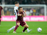 Nicolo Barella of FC Internazionale and Angelino of AS Roma compete for the ball during the Serie A Enilive match between AS Roma and FC Int...