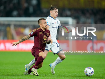 Angelino of AS Roma and Nicolo Barella of FC Internazionale compete for the ball during the Serie A Enilive match between AS Roma and FC Int...