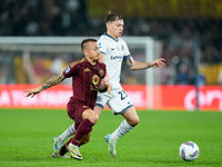 Angelino of AS Roma and Nicolo Barella of FC Internazionale compete for the ball during the Serie A Enilive match between AS Roma and FC Int...