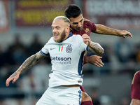 Federico Dimarco of FC Internazionale and Zeki Celik of AS Roma jump for the ball during the Serie A Enilive match between AS Roma and FC In...