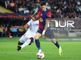 Robert Lewandowski and Marcao play during the match between FC Barcelona and Sevilla FC, corresponding to week 10 of LaLiga EA Sports, at th...