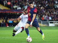 Robert Lewandowski and Marcao play during the match between FC Barcelona and Sevilla FC, corresponding to week 10 of LaLiga EA Sports, at th...