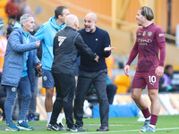 Manchester City's manager Pep Guardiola protests the referee's decision for VAR to check Stones' goal during the Premier League match betwee...