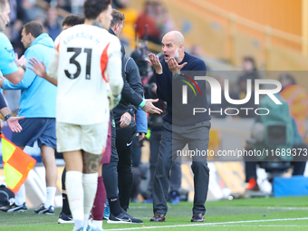 Manchester City's manager Pep Guardiola protests the referee's decision for VAR to check Stones' goal during the Premier League match betwee...