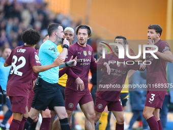 Manchester players await a VAR decision relating to their second goal during the Premier League match between Wolverhampton Wanderers and Ma...