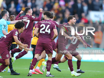 Manchester's players celebrate after VAR upholds their second goal during the Premier League match between Wolverhampton Wanderers and Manch...