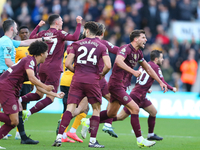 Manchester's players celebrate after VAR upholds their second goal during the Premier League match between Wolverhampton Wanderers and Manch...