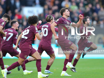 Manchester's players celebrate after VAR upholds their second goal during the Premier League match between Wolverhampton Wanderers and Manch...