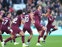 Manchester's players celebrate after VAR upholds their second goal during the Premier League match between Wolverhampton Wanderers and Manch...