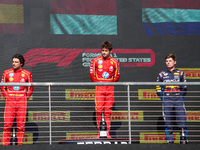 Charles Leclerc, Carlos Sainz Jr., and Max Verstappen stand on the podium during the Formula 1 Pirelli United States Grand Prix 2024 in Aust...