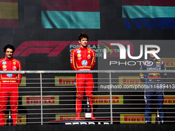 Charles Leclerc, Carlos Sainz Jr., and Max Verstappen stand on the podium during the Formula 1 Pirelli United States Grand Prix 2024 in Aust...