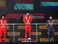 Charles Leclerc, Carlos Sainz Jr., and Max Verstappen stand on the podium during the Formula 1 Pirelli United States Grand Prix 2024 in Aust...