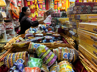 A woman shops for diyas (decorative earthen lamps) and Diwali decorations at a shop selling puja items in preparation for the festival of Di...