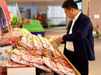 Visitors visit the exhibition hall at Shuanghui Group headquarters in Luohe, China, on October 21, 2024. (