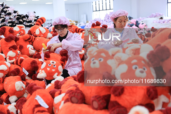 Workers rush to make plush toys for export at a toy company in Chengtou town, Ganyu district, Lianyungang, China, on October 21, 2024. 