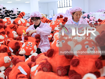 Workers rush to make plush toys for export at a toy company in Chengtou town, Ganyu district, Lianyungang, China, on October 21, 2024. (