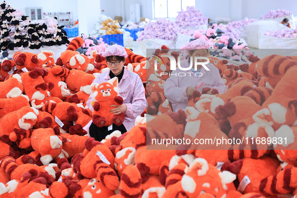 Workers rush to make plush toys for export at a toy company in Chengtou town, Ganyu district, Lianyungang, China, on October 21, 2024. 