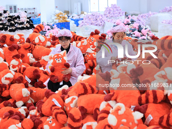 Workers rush to make plush toys for export at a toy company in Chengtou town, Ganyu district, Lianyungang, China, on October 21, 2024. (