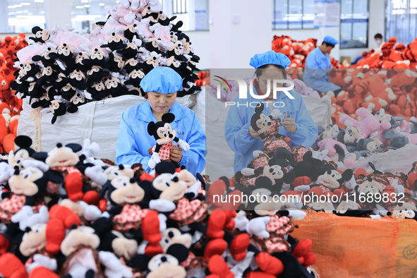 Workers rush to make plush toys for export at a toy company in Chengtou town, Ganyu district, Lianyungang, China, on October 21, 2024. 