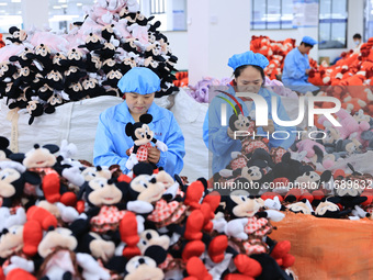 Workers rush to make plush toys for export at a toy company in Chengtou town, Ganyu district, Lianyungang, China, on October 21, 2024. (