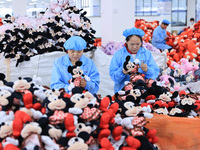 Workers rush to make plush toys for export at a toy company in Chengtou town, Ganyu district, Lianyungang, China, on October 21, 2024. (