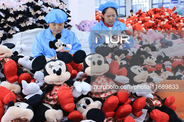 Workers rush to make plush toys for export at a toy company in Chengtou town, Ganyu district, Lianyungang, China, on October 21, 2024. 