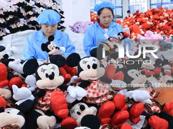 Workers rush to make plush toys for export at a toy company in Chengtou town, Ganyu district, Lianyungang, China, on October 21, 2024. (