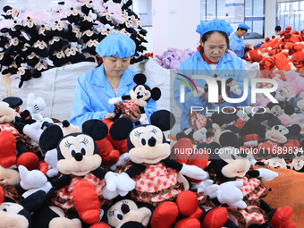 Workers rush to make plush toys for export at a toy company in Chengtou town, Ganyu district, Lianyungang, China, on October 21, 2024. (