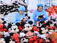 Workers rush to make plush toys for export at a toy company in Chengtou town, Ganyu district, Lianyungang, China, on October 21, 2024. (